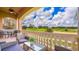 Spacious balcony with seating overlooking a beautiful golf course and lush landscaping at 7411 Excitement Dr, Reunion, FL 34747