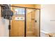 Walk-in shower featuring tile, glass doors, and a window for natural light at 7411 Excitement Dr, Reunion, FL 34747