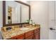 Bathroom with a granite countertop and bronze fixtures at 7411 Excitement Dr, Reunion, FL 34747