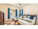 Bright bedroom with a pair of beds, blue accents, and geometric flooring creates a cozy, inviting space at 7411 Excitement Dr, Reunion, FL 34747