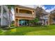 Exterior of property featuring balcony and lush landscaping at 7411 Excitement Dr, Reunion, FL 34747