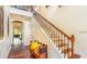 Grand foyer with hardwood floors, decorative tiled staircase, and elegant architectural details at 7411 Excitement Dr, Reunion, FL 34747