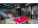 Finished garage converted to a recreational space with a pool table and basketball hoop at 7411 Excitement Dr, Reunion, FL 34747