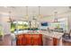Open kitchen featuring a large granite island and golf course views at 7411 Excitement Dr, Reunion, FL 34747