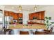 Modern kitchen featuring granite countertops, stainless steel appliances, and pendant lighting at 7411 Excitement Dr, Reunion, FL 34747