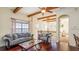 Living room with hardwood floors, stylish furniture, and exposed beams at 7411 Excitement Dr, Reunion, FL 34747
