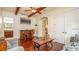 Living room with beamed ceiling, wet bar and access to other rooms at 7411 Excitement Dr, Reunion, FL 34747