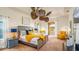 A spacious bedroom with a fan, a tray ceiling, and a private balcony at 7411 Excitement Dr, Reunion, FL 34747