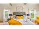 Bright bedroom with a comfortable bed, stylish decor, and natural light from two large windows at 7411 Excitement Dr, Reunion, FL 34747