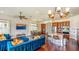 Open concept living space featuring kitchen, dining, and living areas with hardwood floors at 7411 Excitement Dr, Reunion, FL 34747