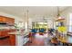 Bright open-concept living space featuring a modern kitchen and a comfortable living area with hardwood floors at 7411 Excitement Dr, Reunion, FL 34747