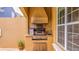 Built-in outdoor kitchen with a stainless steel grill, perfect for summer barbecues and poolside entertaining at 7411 Excitement Dr, Reunion, FL 34747