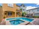 Private pool and spa surrounded by stylish outdoor seating offers an oasis for relaxation and entertainment at 7411 Excitement Dr, Reunion, FL 34747
