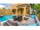 Inviting backyard oasis with a sparkling pool, outdoor kitchen, and comfortable seating for al fresco living at 7411 Excitement Dr, Reunion, FL 34747