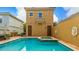Inviting pool and spa featuring a deck and two-story building with two doors and a Juliette balcony at 7411 Excitement Dr, Reunion, FL 34747