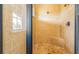 Tiled shower with a frameless glass door, rain shower head, and built-in seat at 7411 Excitement Dr, Reunion, FL 34747