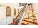 Elegant staircase with decorative tile risers, iron railing, and hardwood treads at 7411 Excitement Dr, Reunion, FL 34747