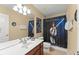 Themed bathroom with a single sink vanity and Star Wars-themed shower curtain at 7754 Teascone Blvd, Kissimmee, FL 34747