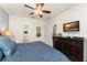 Cozy bedroom featuring a ceiling fan and dresser with a mounted TV at 7754 Teascone Blvd, Kissimmee, FL 34747