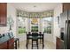 Cozy dining area with large windows and decorative window treatment providing ample natural light at 7754 Teascone Blvd, Kissimmee, FL 34747