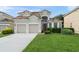 Charming two-story home featuring a tile roof, two-car garage, and well-maintained landscaping at 7754 Teascone Blvd, Kissimmee, FL 34747