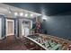 Entertain in this game room featuring a foosball table, arcade game, and convenient laundry closet at 7754 Teascone Blvd, Kissimmee, FL 34747