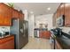 Well-equipped kitchen with stainless steel refrigerator and granite countertops, ample storage at 7754 Teascone Blvd, Kissimmee, FL 34747
