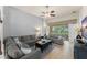 Comfortable living room with tile floors, ceiling fan, and a sliding glass door to the lanai at 7754 Teascone Blvd, Kissimmee, FL 34747