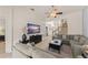 Inviting living room featuring tile floors, plush seating and a view into the dining area at 7754 Teascone Blvd, Kissimmee, FL 34747