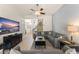 Open concept living room with tile floors, comfortable seating, and access to the staircase at 7754 Teascone Blvd, Kissimmee, FL 34747