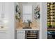 Cozy bar area featuring glass shelving, countertop space, and a wine fridge at 7974 Chilton Dr, Orlando, FL 32836