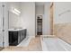 Bathroom with soaking tub, walk-in closet, and dual sink vanity at 7974 Chilton Dr, Orlando, FL 32836