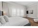 This bedroom has lots of natural light, wood-look flooring, and a flat screen TV at 7974 Chilton Dr, Orlando, FL 32836