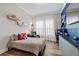 A sports themed bedroom features built in storage, wood-look floors and desk space at 7974 Chilton Dr, Orlando, FL 32836