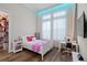 Bright bedroom with hardwood floors, closet, and modern furnishings at 7974 Chilton Dr, Orlando, FL 32836