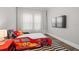 Bright bedroom with race car bed, and black and white striped rug at 7974 Chilton Dr, Orlando, FL 32836