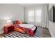 bedroom design with race car bed, striped rug, and natural light at 7974 Chilton Dr, Orlando, FL 32836