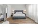 This bedroom features a gray upholstered bed frame, and wood-look flooring at 7974 Chilton Dr, Orlando, FL 32836