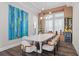 Formal dining room with modern lighting, wine storage, and a large table with seating for eight at 7974 Chilton Dr, Orlando, FL 32836