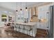 Spacious kitchen with a large center island, seating, modern appliances, and natural light at 7974 Chilton Dr, Orlando, FL 32836