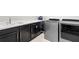 Laundry room featuring modern gray appliances and dark cabinetry at 7974 Chilton Dr, Orlando, FL 32836
