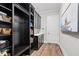 Hallway boasts built-in storage, wooden floors and neutral walls at 7974 Chilton Dr, Orlando, FL 32836