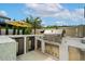 Outdoor kitchen area with stainless steel grill, mini fridge, white countertops, and seating area at 7974 Chilton Dr, Orlando, FL 32836