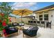 Outdoor kitchen and living space, featuring a built in grill, bar seating, and ample seating at 7974 Chilton Dr, Orlando, FL 32836