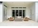 Cozy outdoor living room with a fire pit, comfortable seating, and access to the home through sliding glass doors at 7974 Chilton Dr, Orlando, FL 32836
