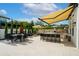 Spacious outdoor patio with dining area, lounge seating, bar with stools, and retractable awning at 7974 Chilton Dr, Orlando, FL 32836