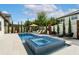Inviting pool and spa featuring sun loungers, landscaped with manicured trees and plants for privacy at 7974 Chilton Dr, Orlando, FL 32836