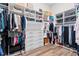 This walk-in closet has custom shelving and plenty of storage for clothes and accessories at 7974 Chilton Dr, Orlando, FL 32836