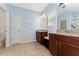 Bright bathroom featuring dual granite vanities and tiled flooring at 9348 Meadow Hunt Way, Winter Garden, FL 34787