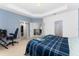 Spacious bedroom with a tray ceiling, a Minecraft themed blanket, and ample closet space at 9348 Meadow Hunt Way, Winter Garden, FL 34787